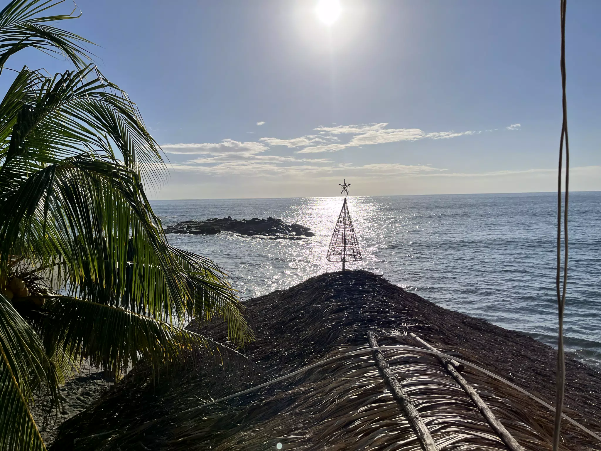 Rooftop Tropical Christmas Tree with Setting Sun on Pacific Ocean