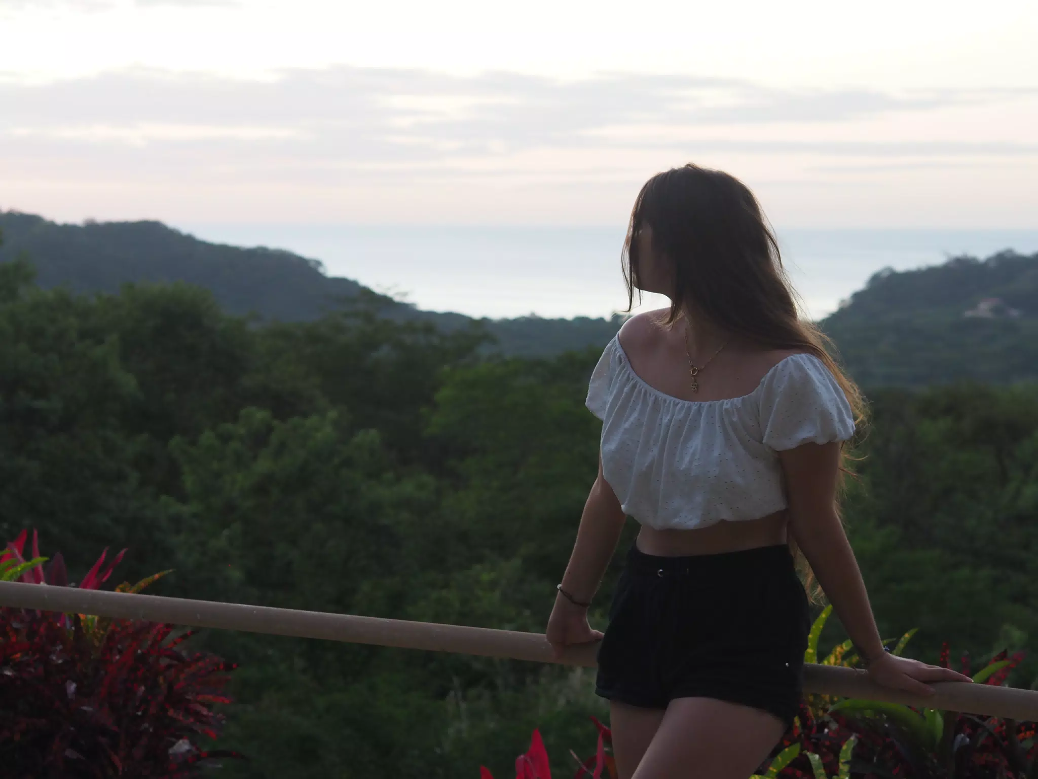 Camille Sitting on Railing Looking at the Pacific Ocean