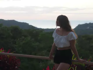 Camille Sitting on Railing Looking at the Pacific Ocean