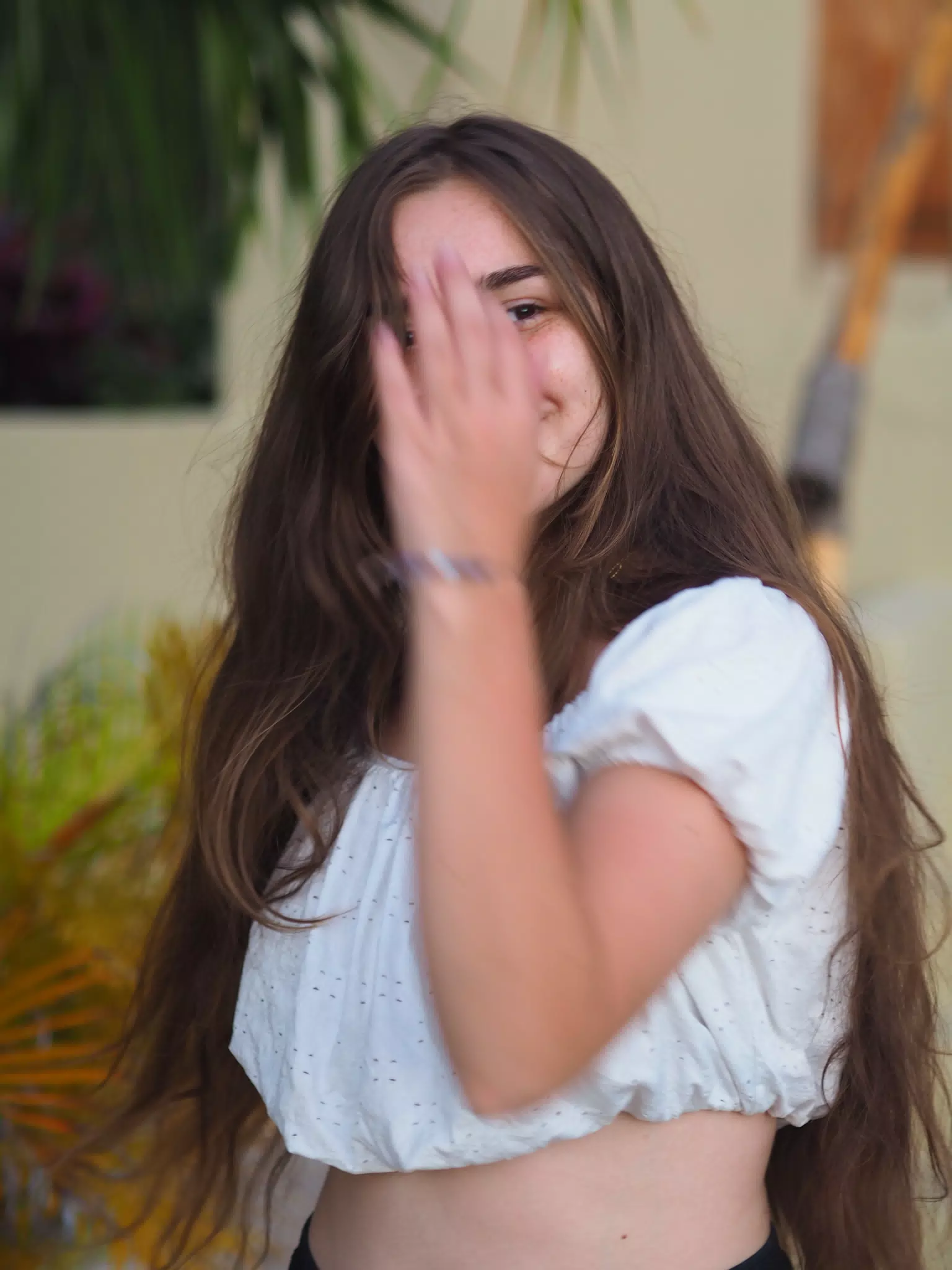 Smiling Teen with Hand in Front of Face