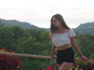 Camille in White Top and Shorts by Pacific Ocean