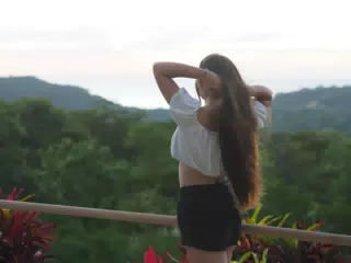 Teen Model Adjusting Hair by Pacific Ocean in San Juan del Sur, Nicaragua
