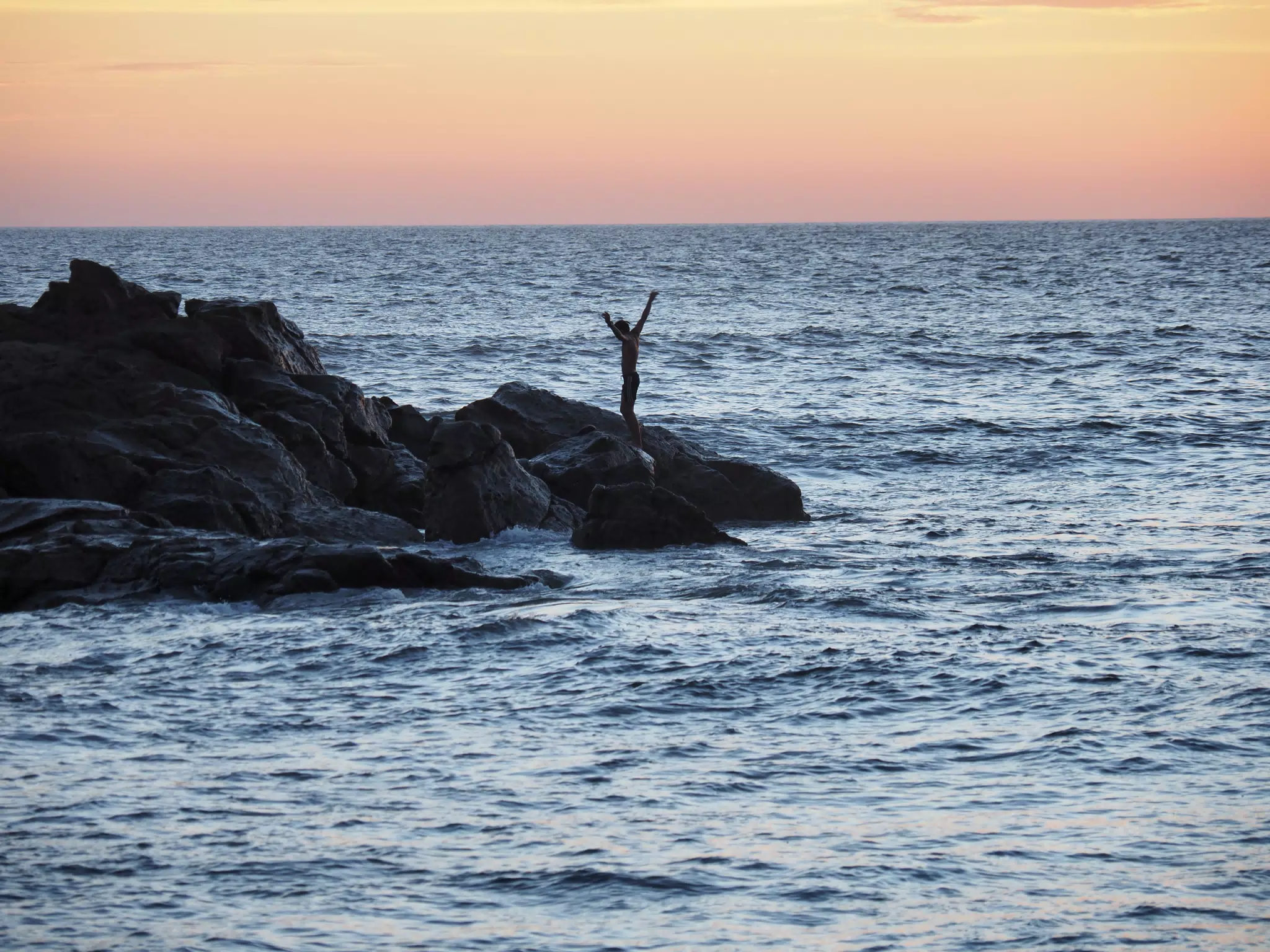 Sunset Reveler on the Rocks at The Simple Beach Lodge in Las Peñitas Nicaragua