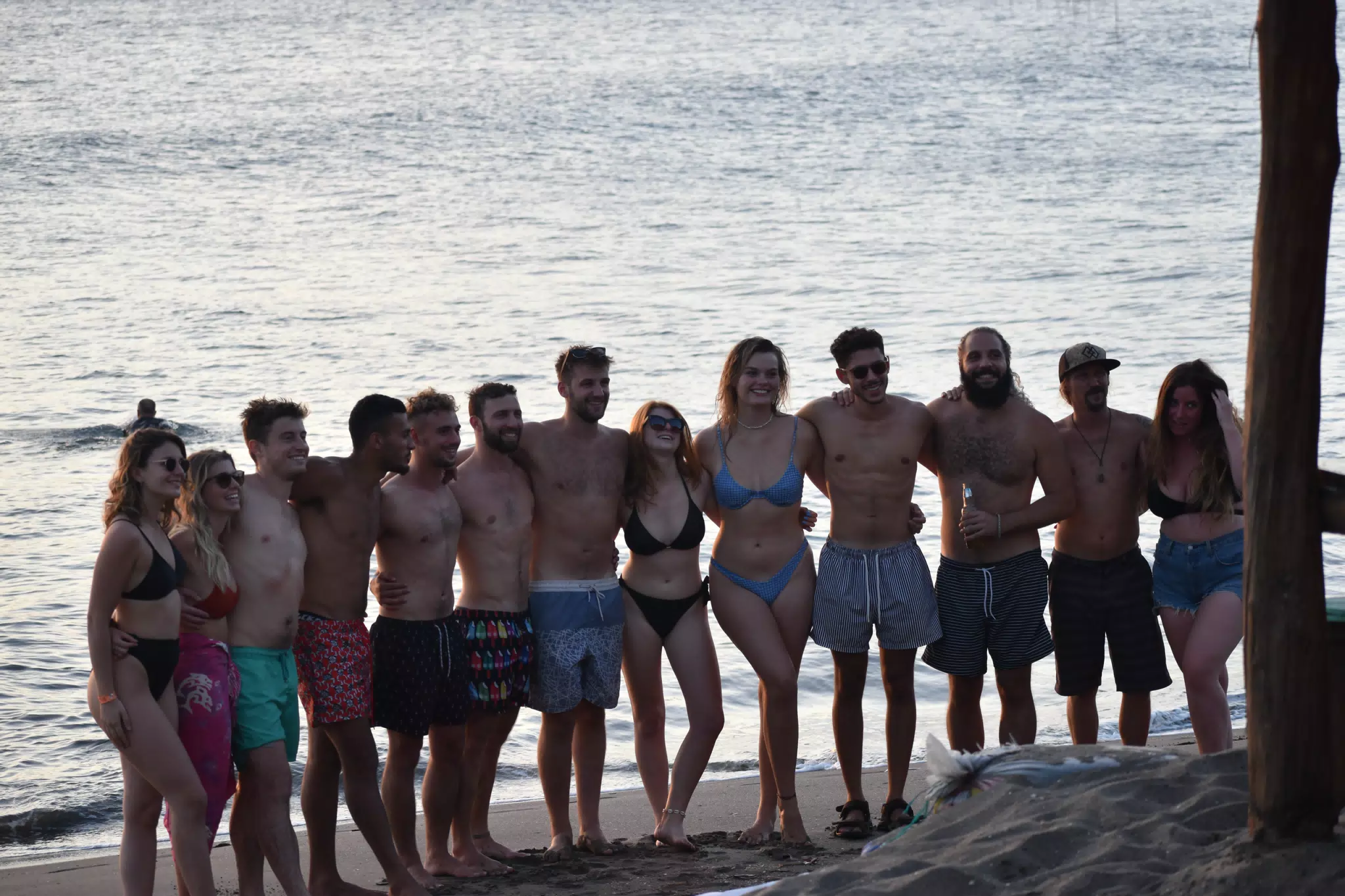 People in Swimsuits on the Beach Staying at Simple Beach Lodge