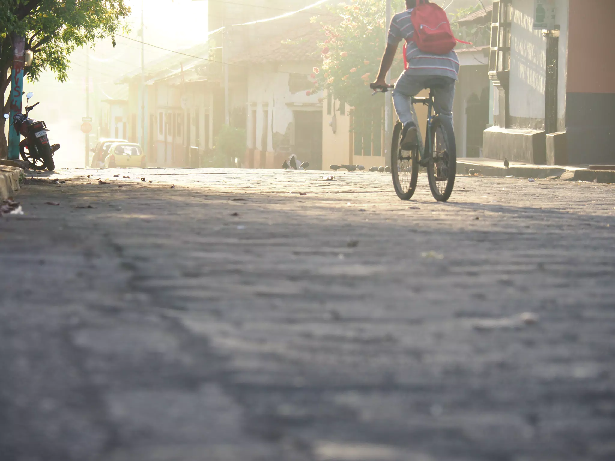 Bicycle and Moto at Sunrise on 5th Calle, León, Nicaragua