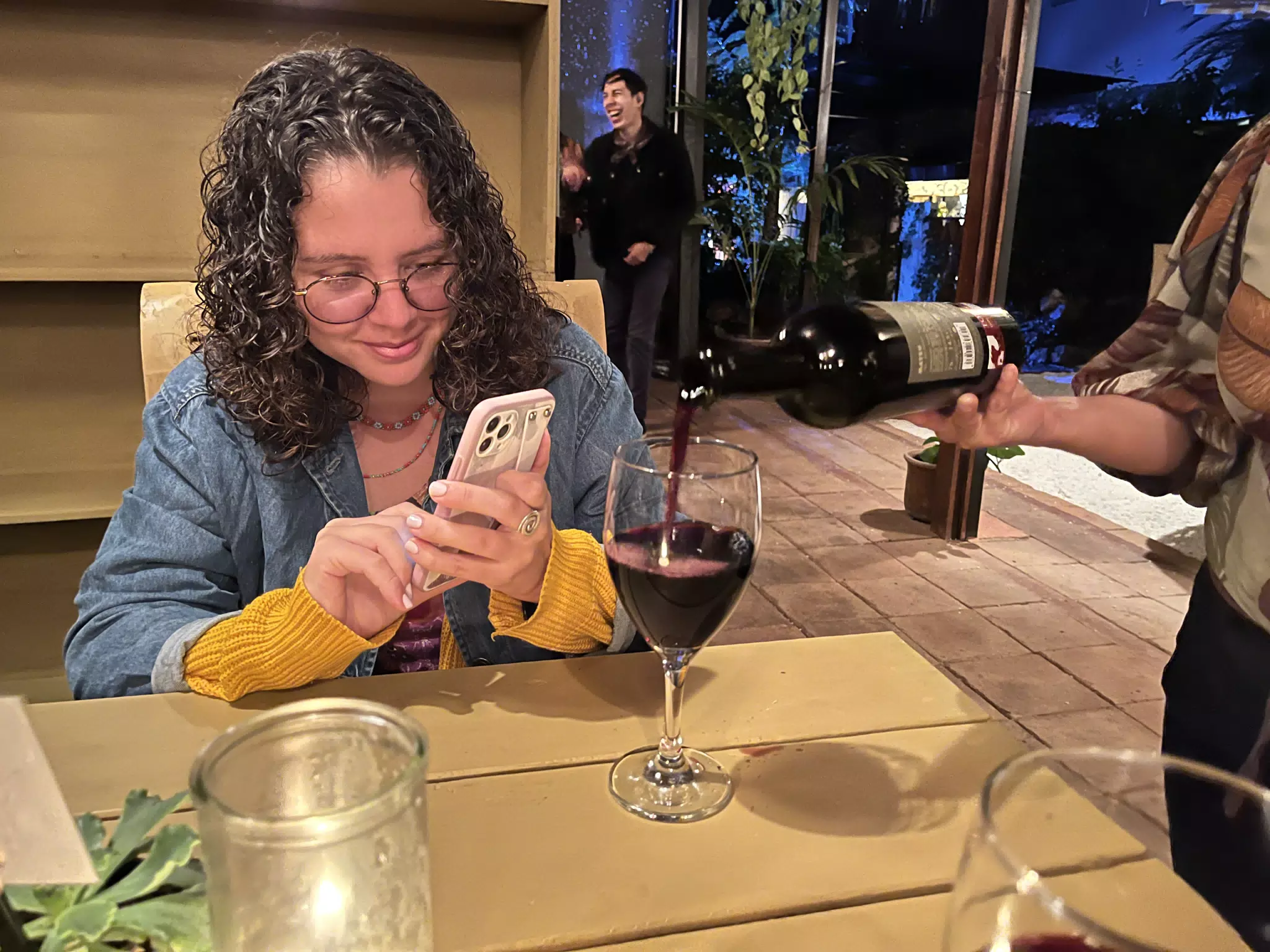 Ivonne Taking a Picture of Her Wine in Antigua, Guatemala