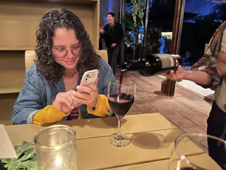 Ivonne Taking a Picture of Her Wine in Antigua, Guatemala
