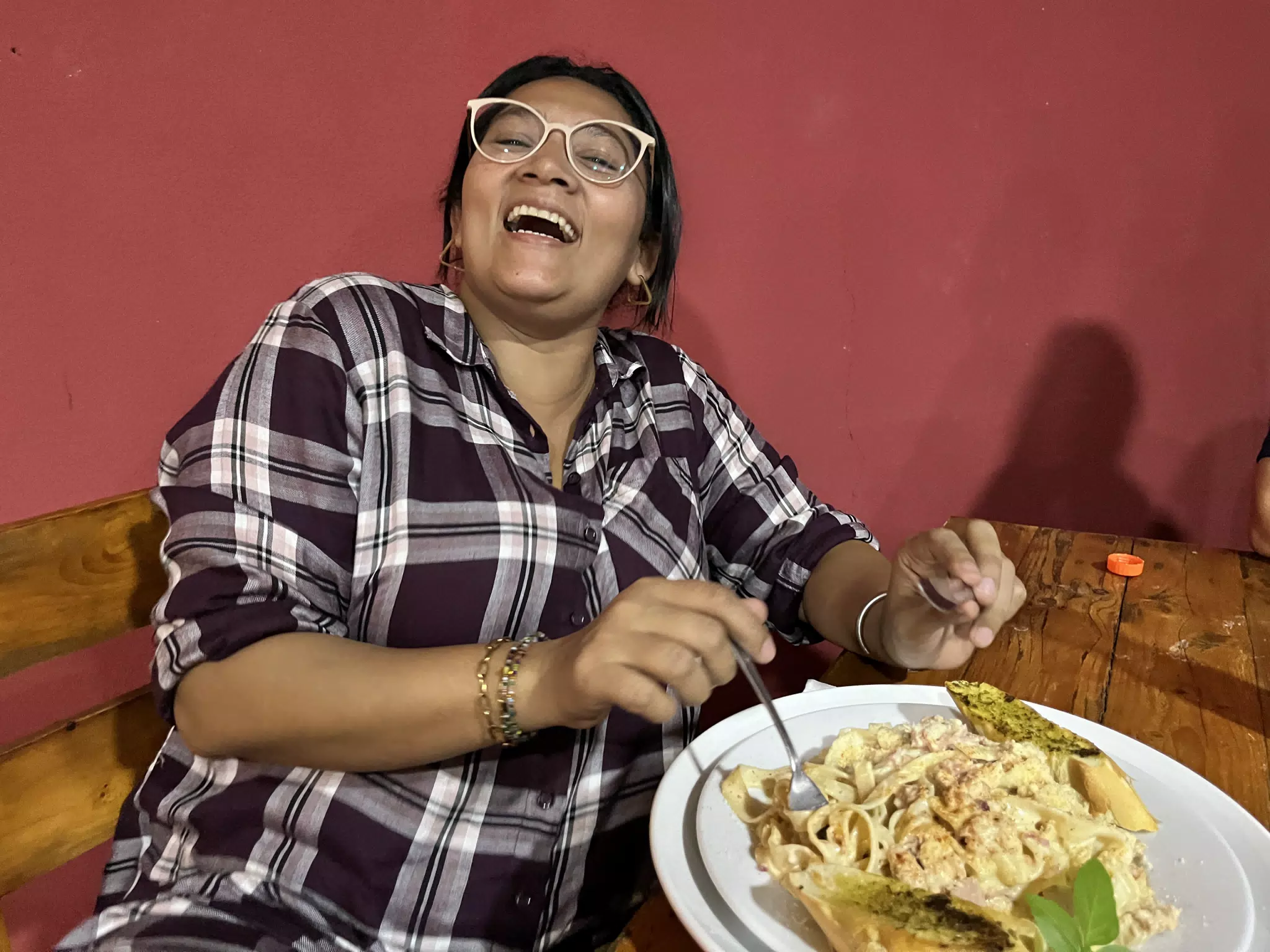 Marcela Laughing with Pasta at Twins Restaurant in Sutiava Nicaragua