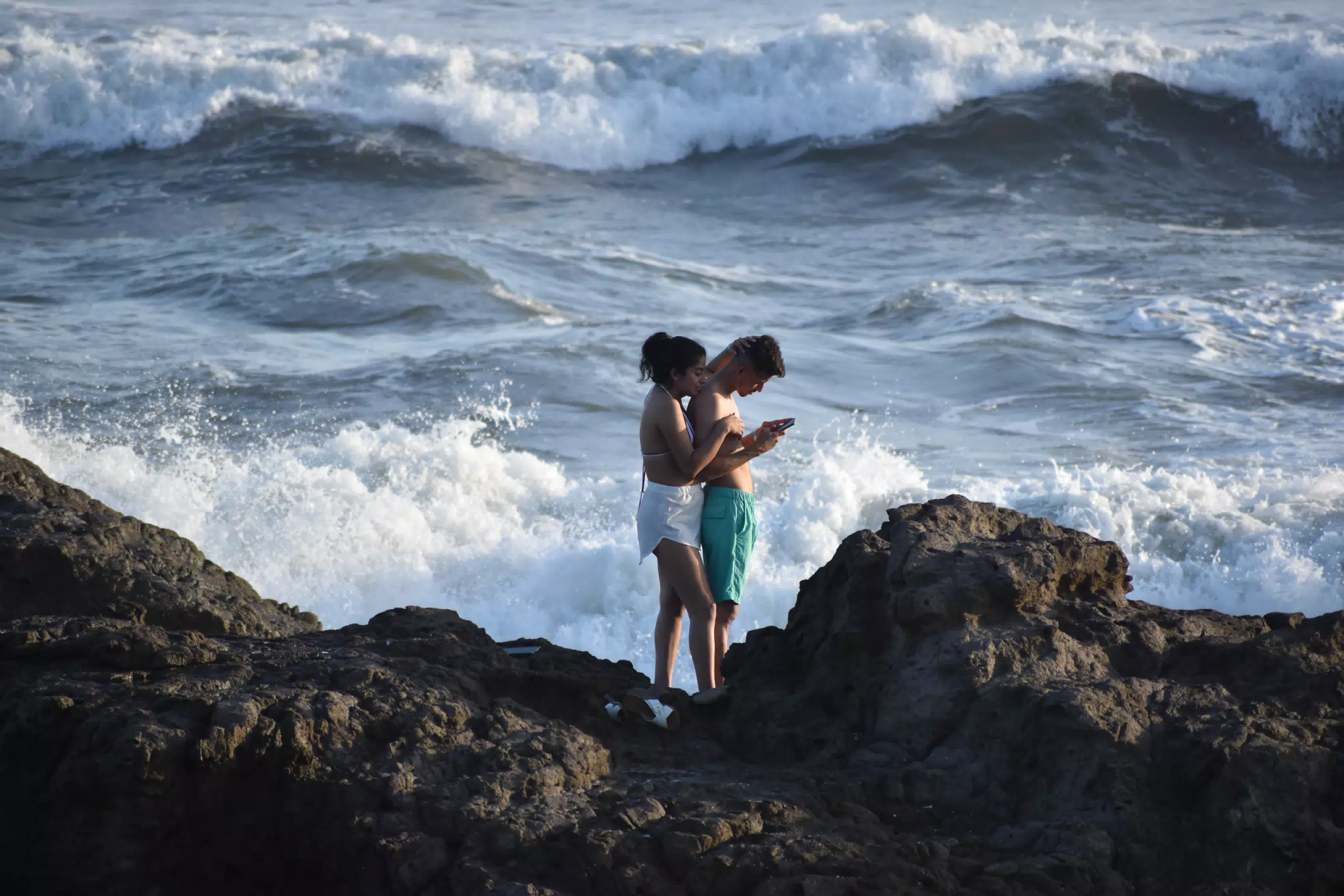 Phone Users on Rocks in Las Peñitas Nicaragua