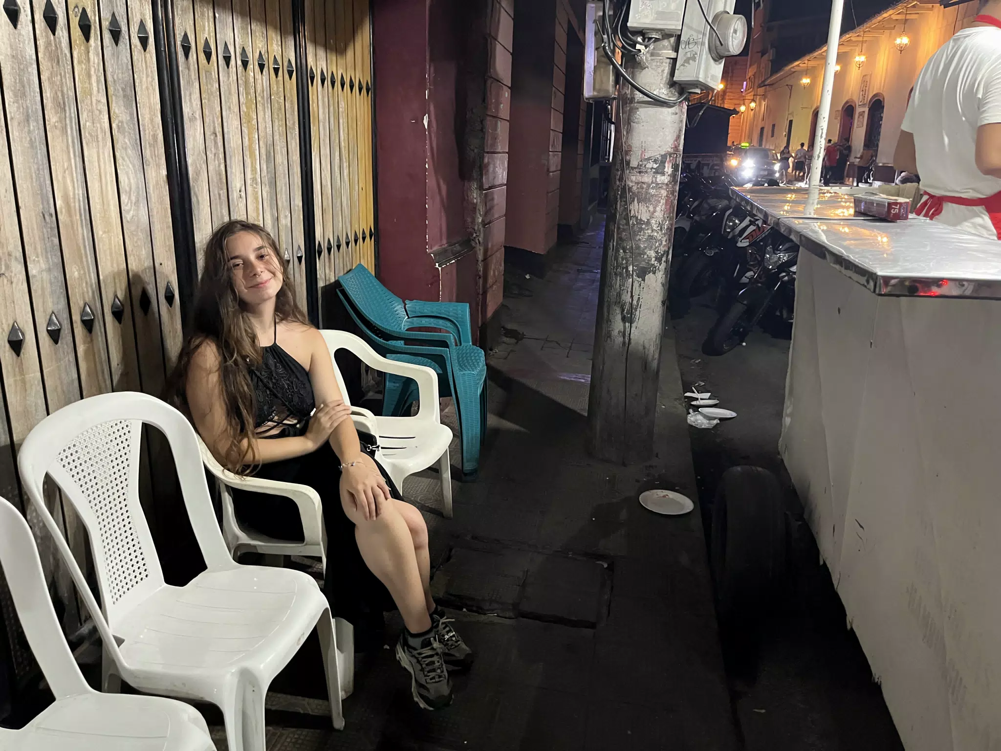 Camille Waiting for a Street Hamburger in León, Nicaragua