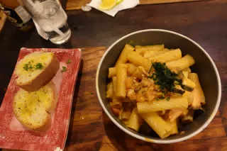 Salmon Pasta with Garlic Bread at SUA León Nicaragua