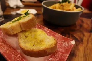 Salmon Pasta with Garlic Bread at SUA León Nicaragua