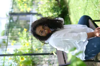 Aida Posing in the Garden with Glasses