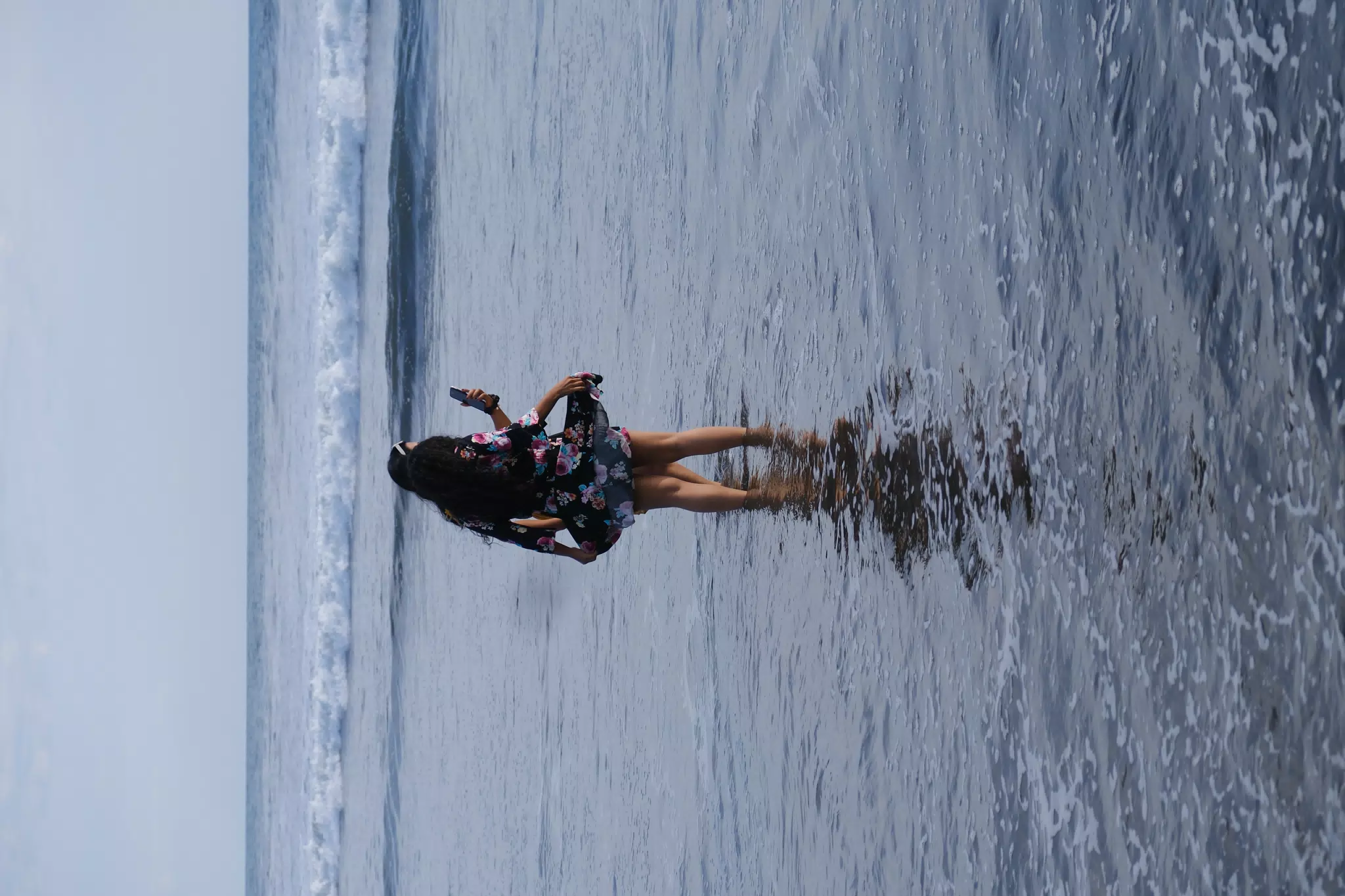Checking Phone in the Ocean