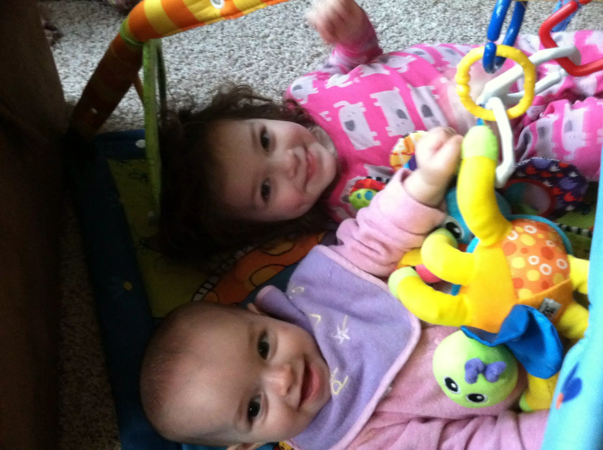 Liesl and Luciana Playing on the Floor Mat